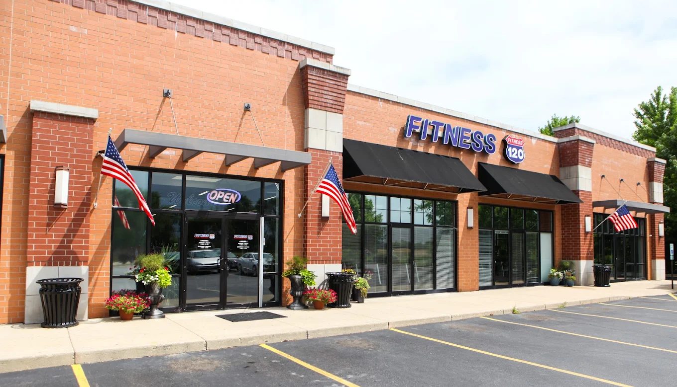 Fitness 120 storefront on Route 120 in McHenry with American flags