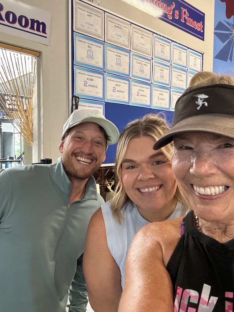 Fitness 120 trainers with a smiling member